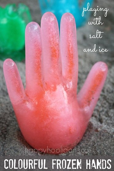 Colourful-frozen-hands-playing-with-salt-and-ice